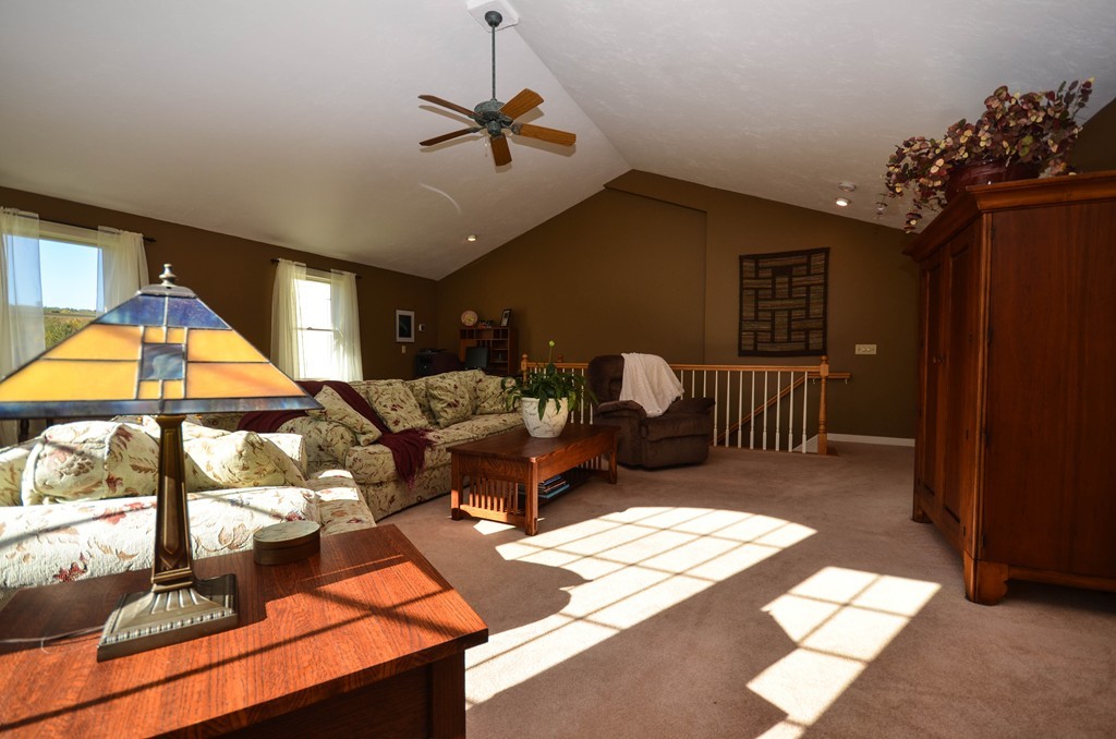 66 Barnett Road Sutton, MA 01590 - Photo 17 of 30 a living room with furniture and a chandelier