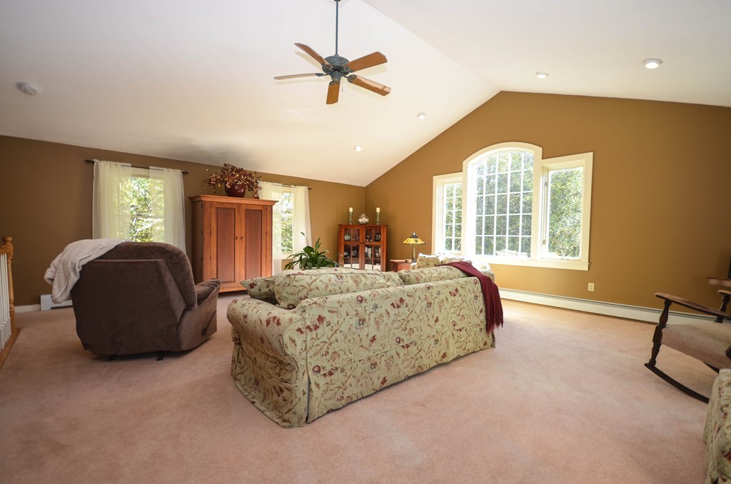 66 Barnett Road Sutton, MA 01590 - Photo 18 of 30 a spacious bedroom with a bed a window and a chandelier