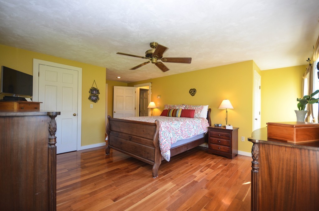 66 Barnett Road Sutton, MA 01590 - Photo 19 of 30 a bedroom with a bed and wooden floor