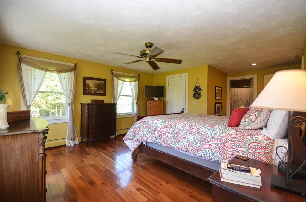 66 Barnett Road Sutton, MA 01590 - Photo 20 of 30 a bedroom with a bed and a chandelier