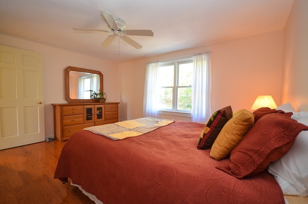 66 Barnett Road Sutton, MA 01590 - Photo 24 of 30 a bedroom with a bed and a dresser with mirror
