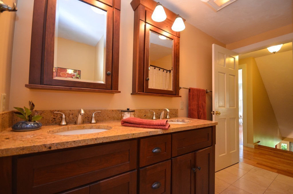 66 Barnett Road Sutton, MA 01590 - Photo 25 of 30 a bathroom with a double vanity sink and a mirror