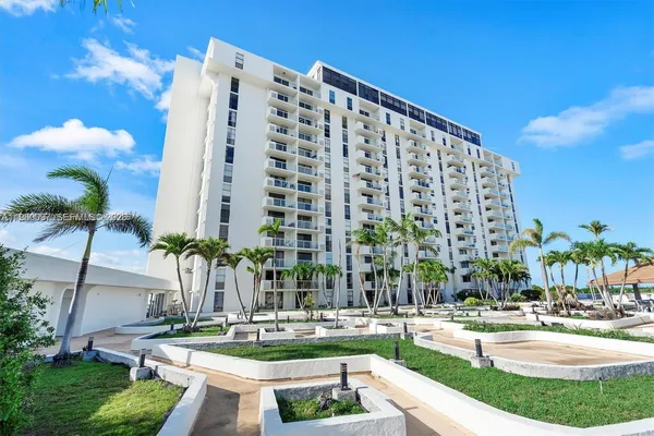 a large building with swimming pool in front of it