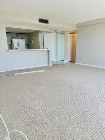 a view of a livingroom with an empty space and a window