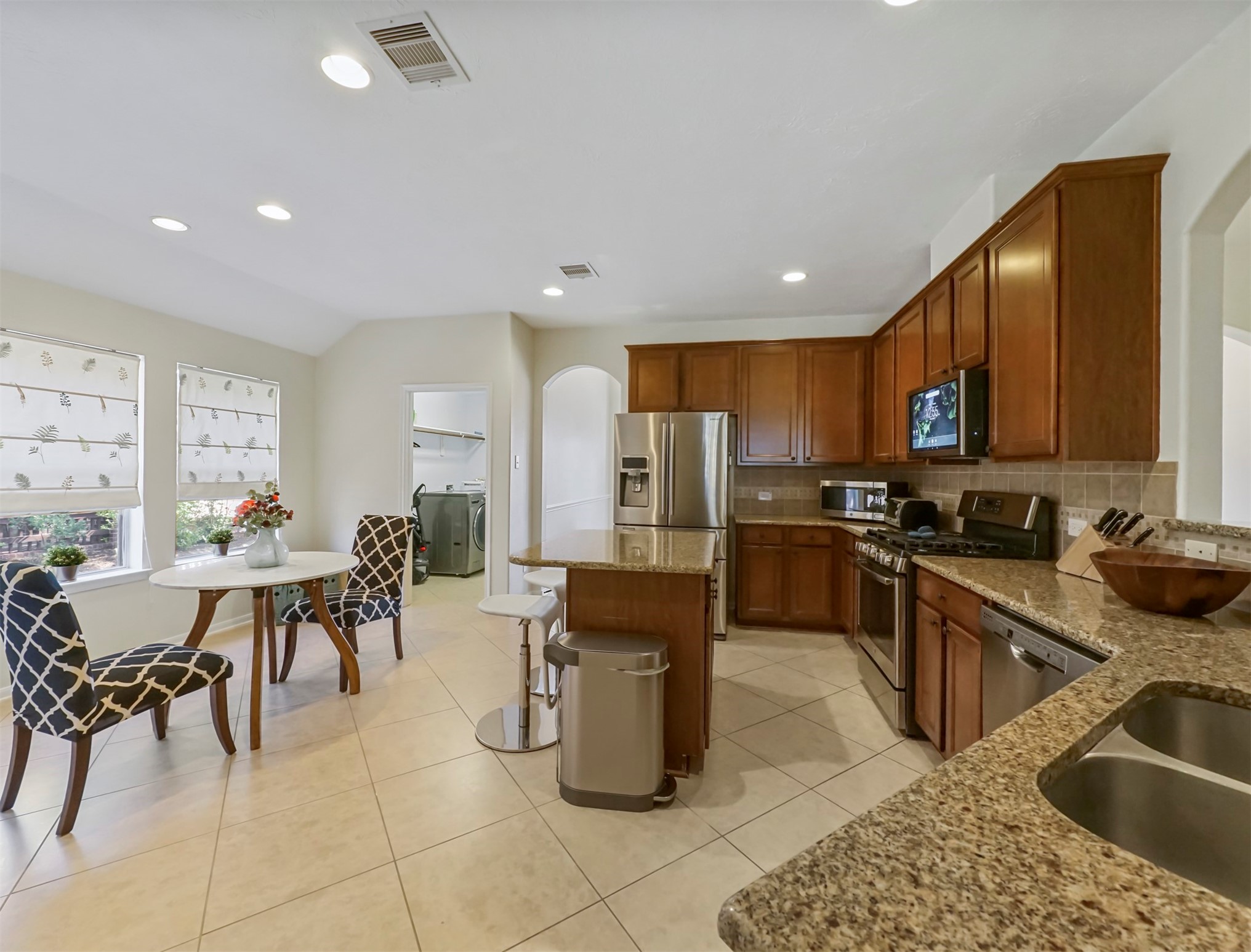 8214 Garrison Point Drive Houston, TX 77040 - Photo 9 of 37 a kitchen with a sink a counter top space appliances and cabinets