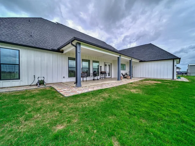 a backyard of a house with table and chairs