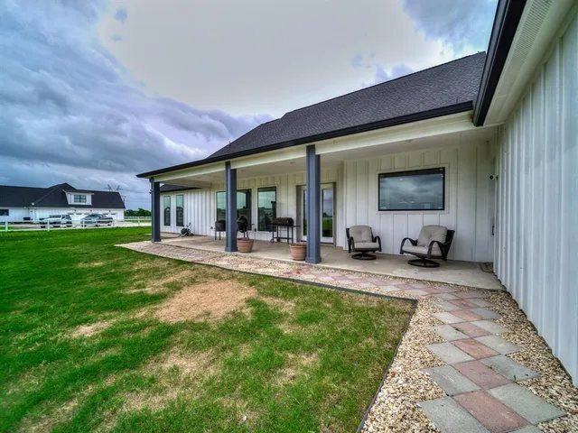 a view of a house with backyard porch and sitting area