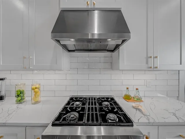 a kitchen with a stove and a sink