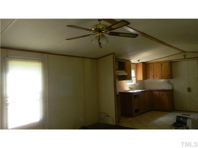 1310 Mollie Mooney Road Roxboro, NC 27574 - Photo 2 of 6 a open kitchen with a sink and cabinets