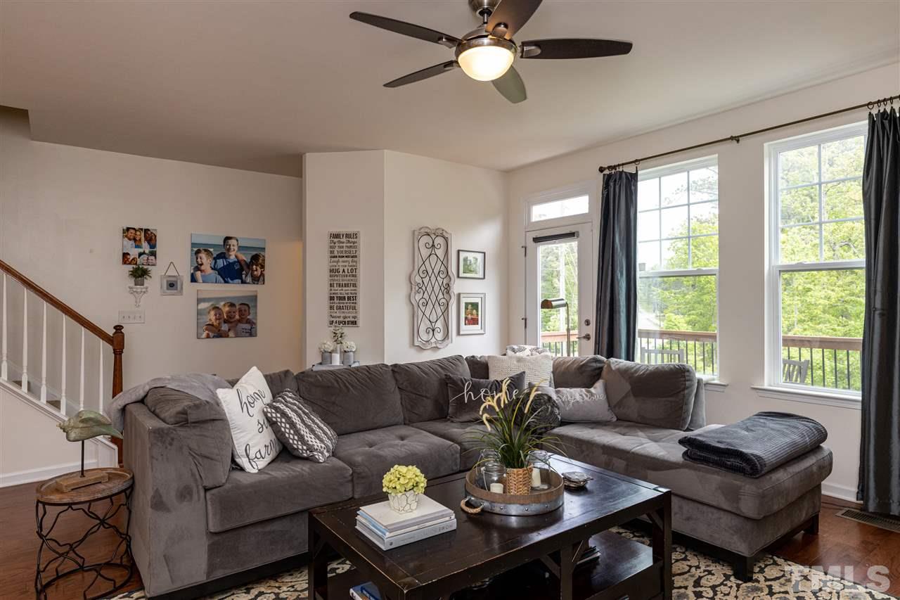 724 Edgewater Ridge Court Apex, NC 27523 - Photo 11 of 30 a living room with furniture and a large window
