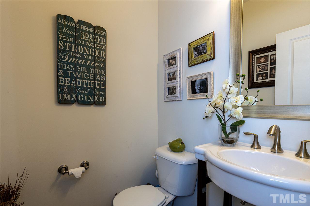 724 Edgewater Ridge Court Apex, NC 27523 - Photo 12 of 30 a bathroom with a toilet sink and mirror