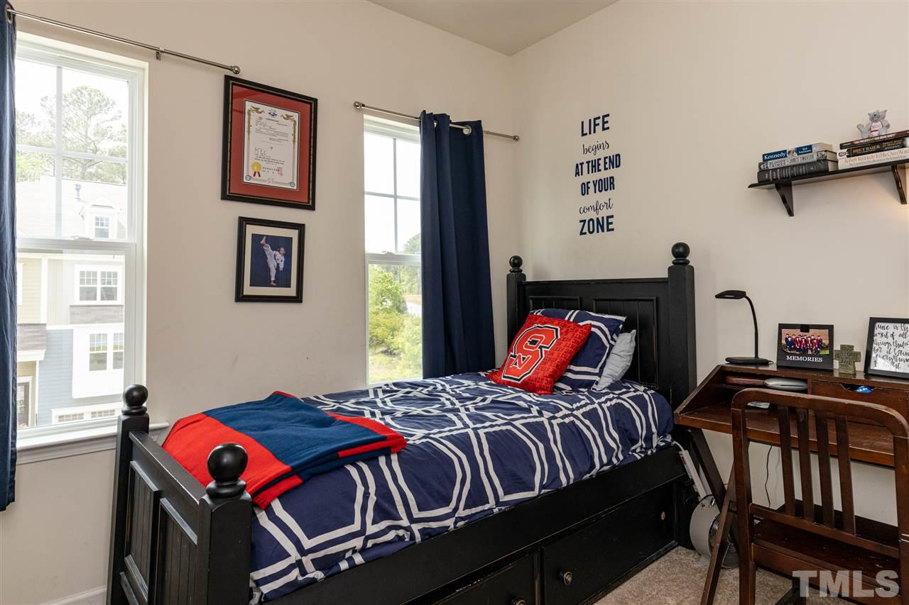 724 Edgewater Ridge Court Apex, NC 27523 - Photo 19 of 30 a bedroom with bed and a window