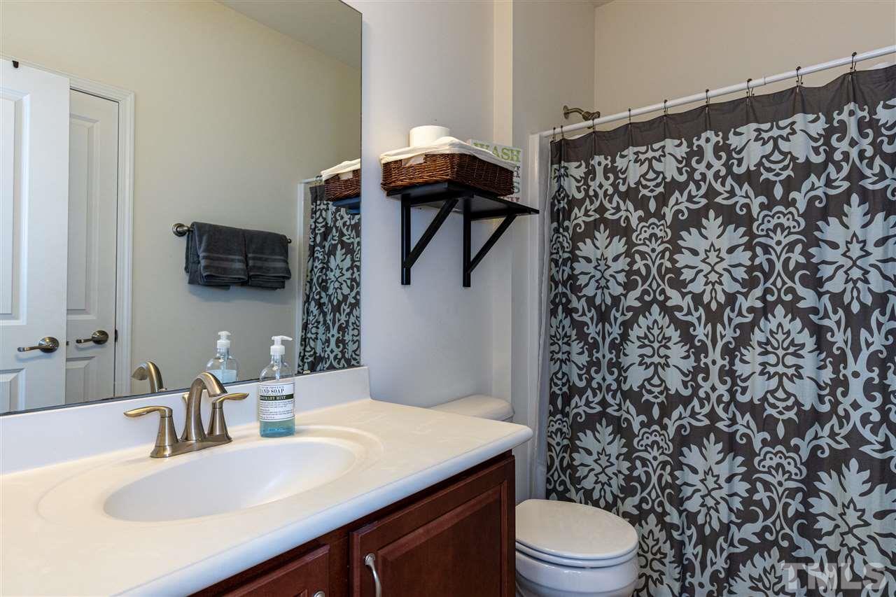 724 Edgewater Ridge Court Apex, NC 27523 - Photo 20 of 30 a bathroom with a sink toilet and shower