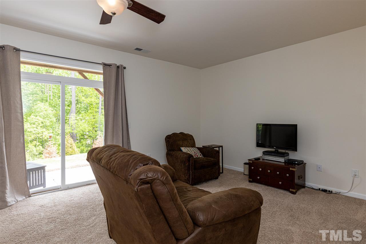 724 Edgewater Ridge Court Apex, NC 27523 - Photo 22 of 30 a living room with furniture and a flat screen tv