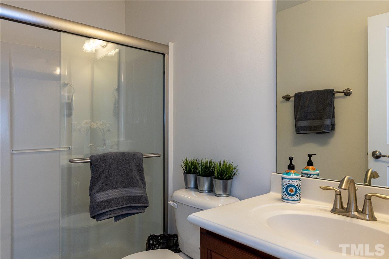 724 Edgewater Ridge Court Apex, NC 27523 - Photo 24 of 30 a bathroom with a sink and a mirror