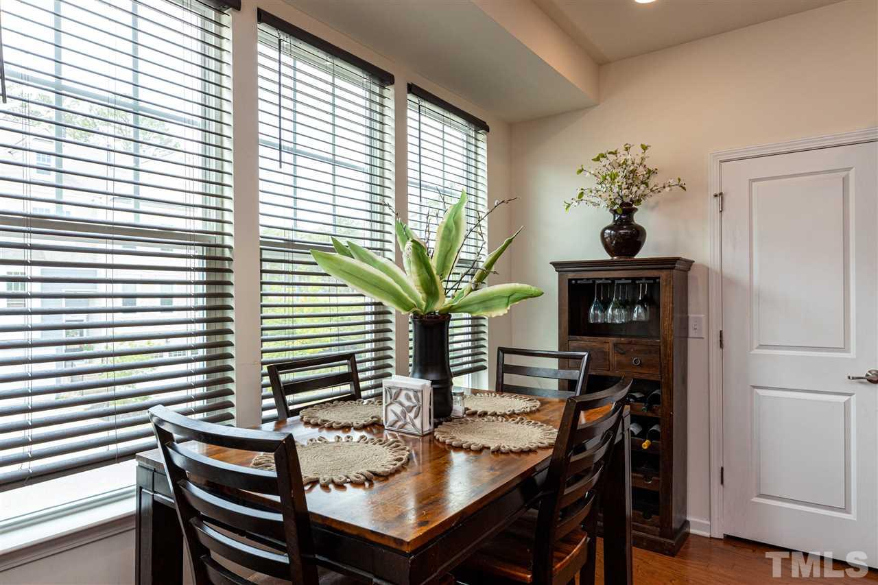 724 Edgewater Ridge Court Apex, NC 27523 - Photo 5 of 30 a view of a dining room with furniture and wooden floor