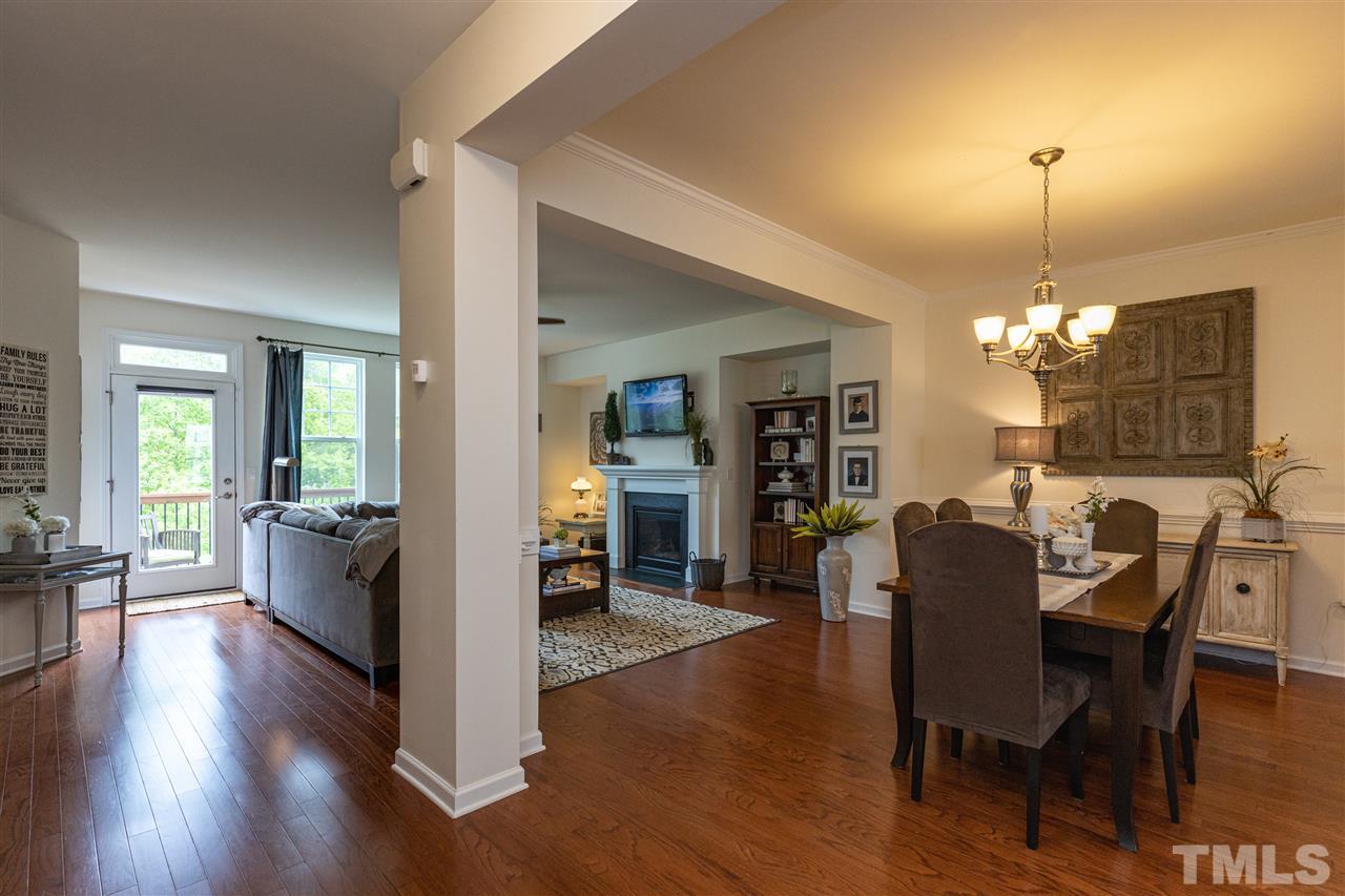 724 Edgewater Ridge Court Apex, NC 27523 - Photo 7 of 30 a view of a dining room with furniture window and wooden floor
