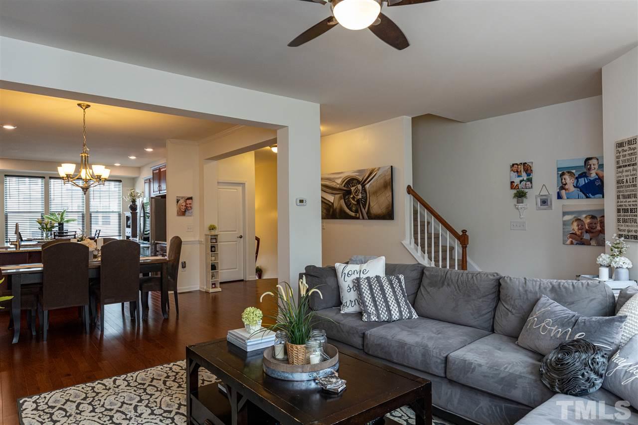 724 Edgewater Ridge Court Apex, NC 27523 - Photo 10 of 30 a living room with furniture kitchen view and a table