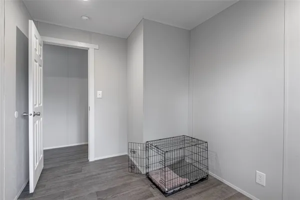 an empty room with wooden floor and closet