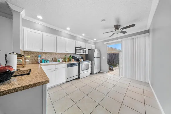 a kitchen with stainless steel appliances granite countertop a refrigerator sink and cabinets