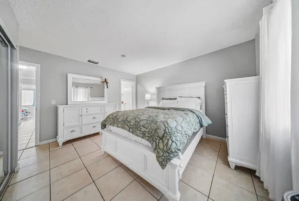 a spacious bedroom with a bed and a view of bathroom
