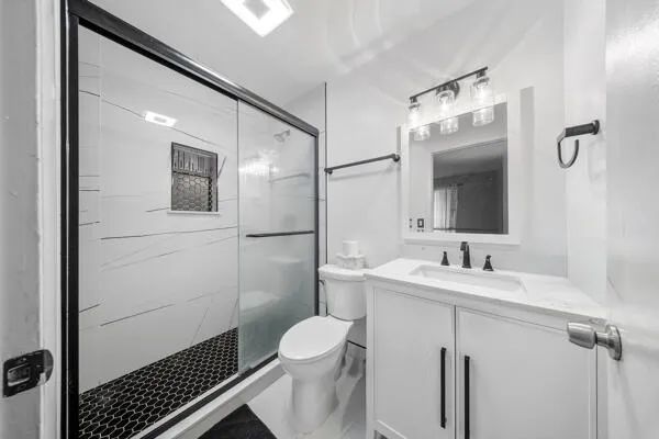 a bathroom with a sink toilet and shower