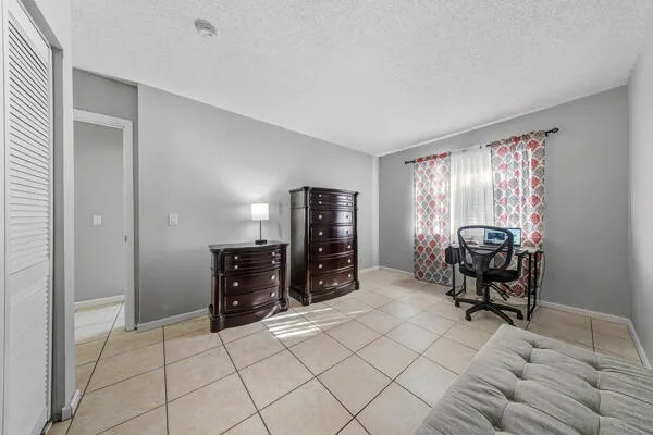 a view of a livingroom with furniture and gym equipment