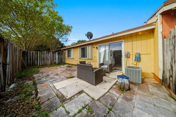 a view of a patio with table and chairs with wooden floor and fence