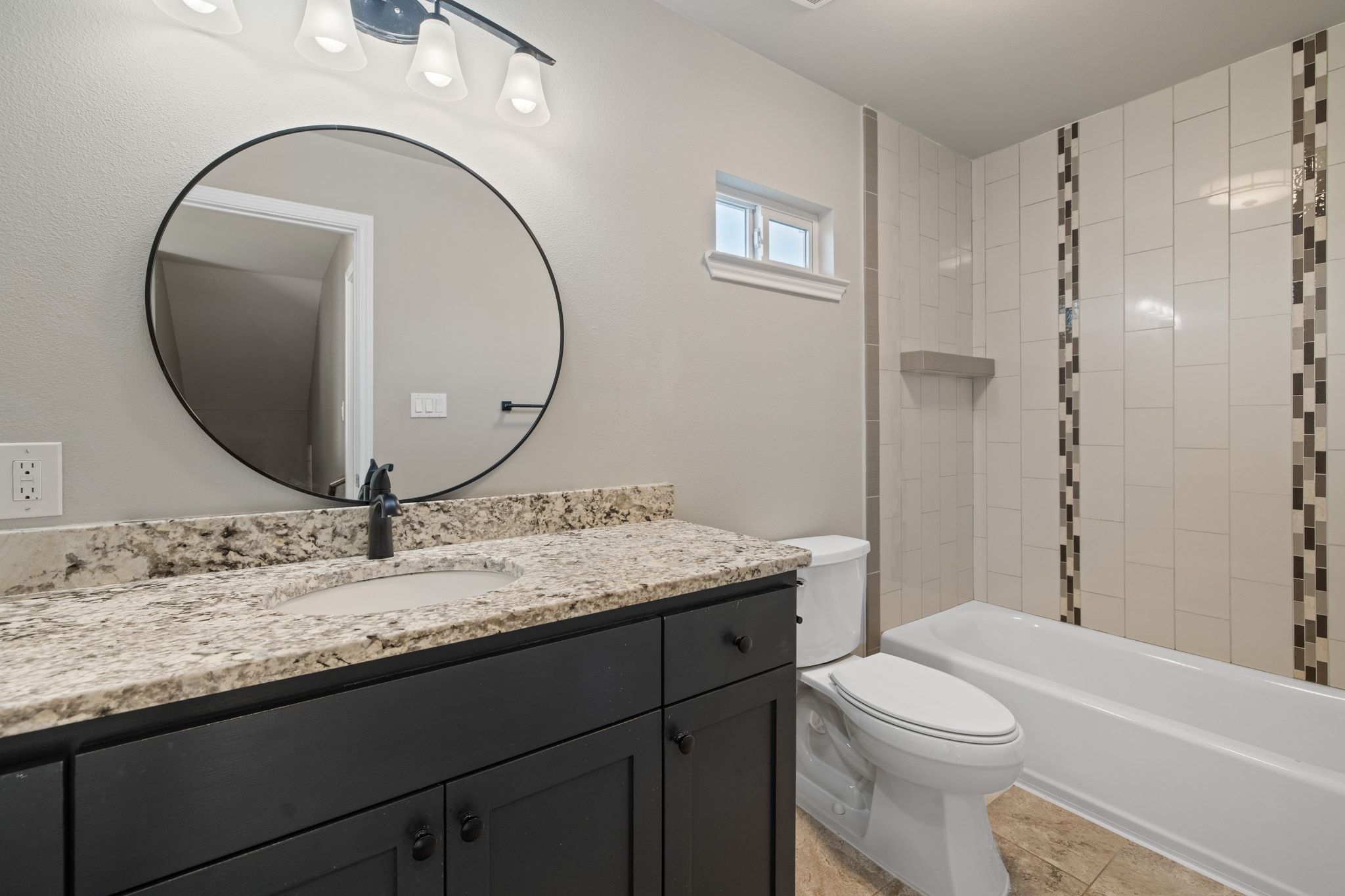 609 A West 7th Street Taylor, TX 76574 - Photo 19 of 35 a bathroom with a granite countertop toilet a sink and a mirror