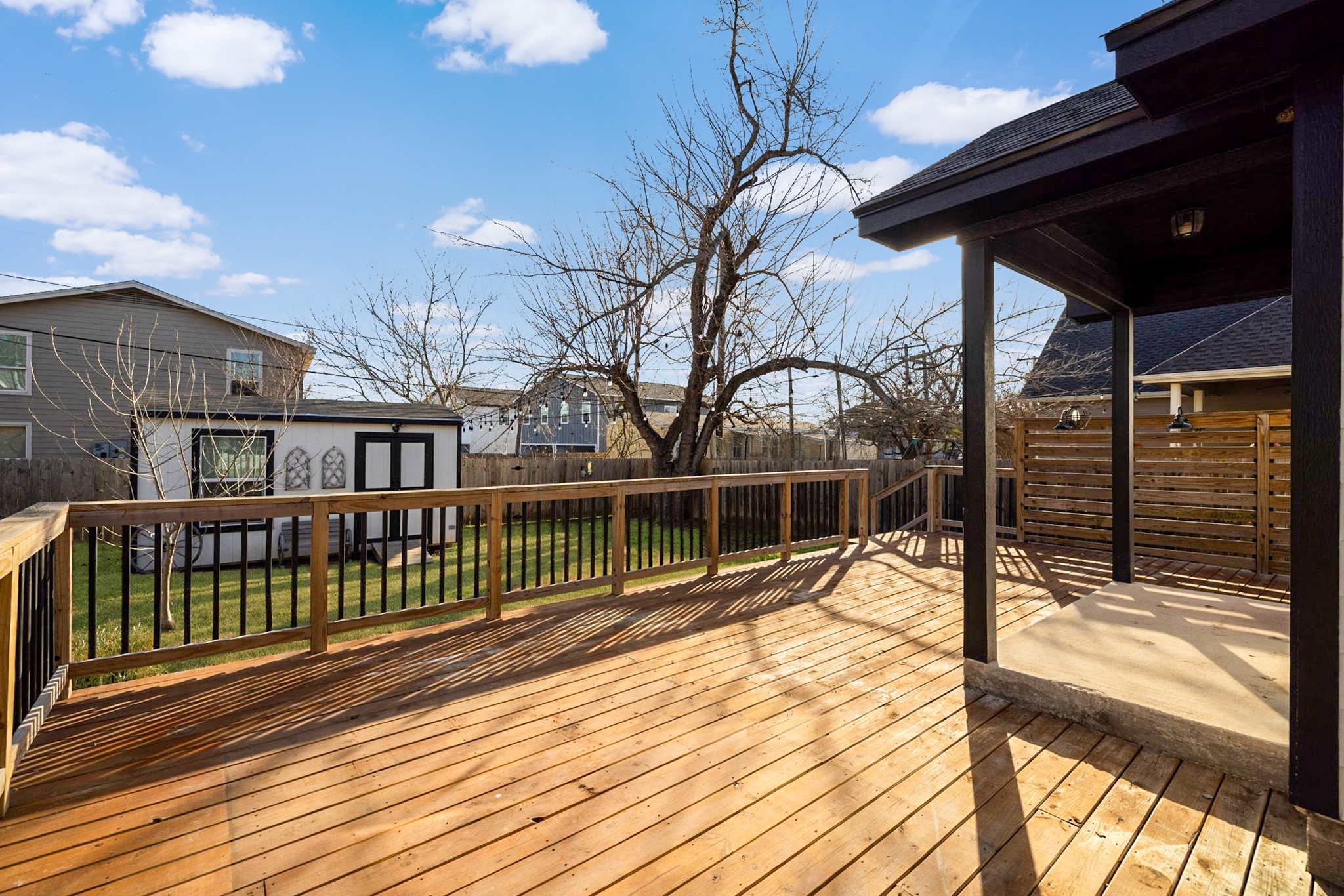 609 A West 7th Street Taylor, TX 76574 - Photo 24 of 35 a view of a balcony with two chairs and wooden floor