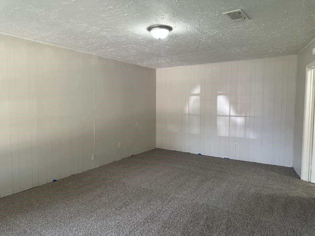 6523 Hanley Lane Houston, TX 77016 - Photo 5 of 17 an empty room with windows and entrance