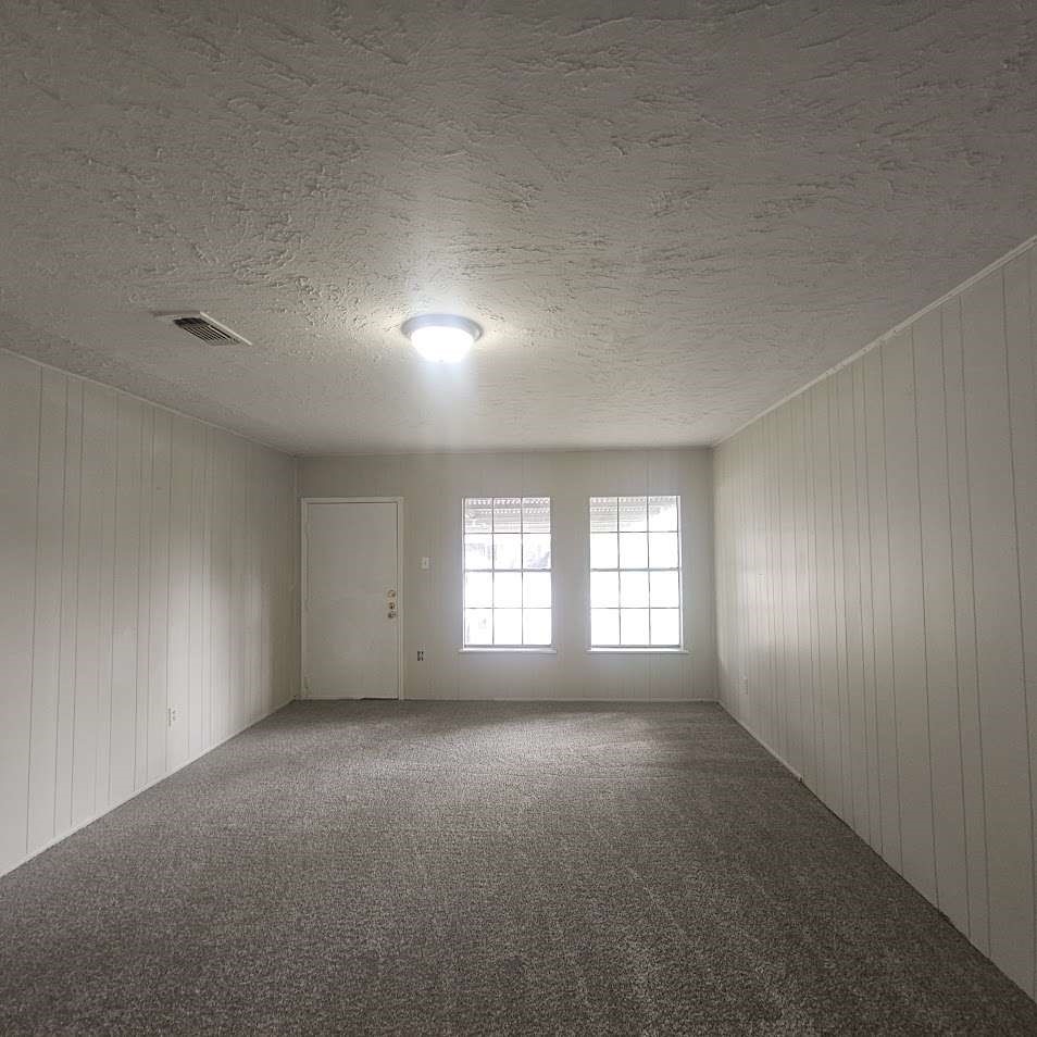 6523 Hanley Lane Houston, TX 77016 - Photo 6 of 17 an empty room with windows