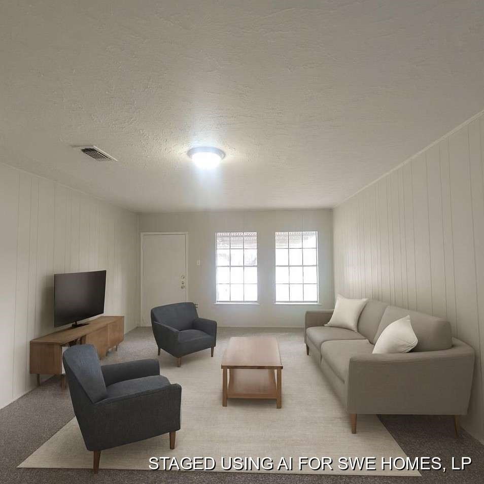 6523 Hanley Lane Houston, TX 77016 - Photo 7 of 17 a living room with furniture and a flat screen tv