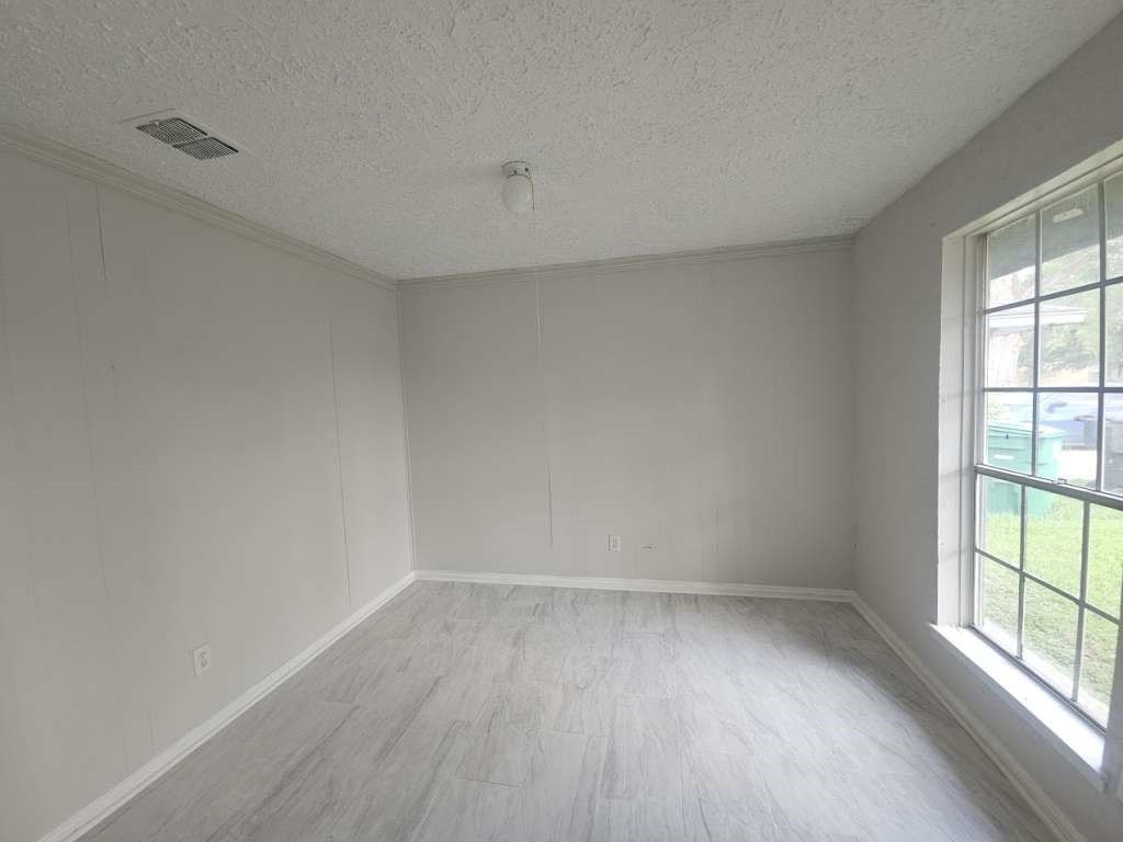 6523 Hanley Lane Houston, TX 77016 - Photo 8 of 17 wooden floor in an empty room with a window