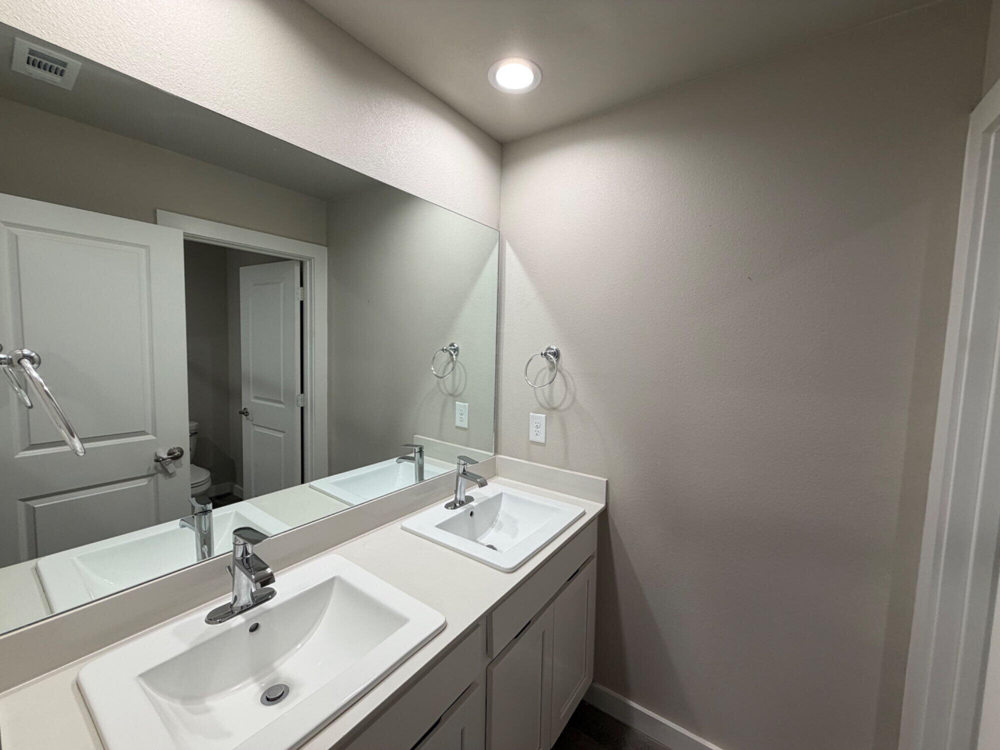 328 Ranger Street Wolfforth, TX 79382 - Photo 13 of 15 a bathroom with a sink and a mirror