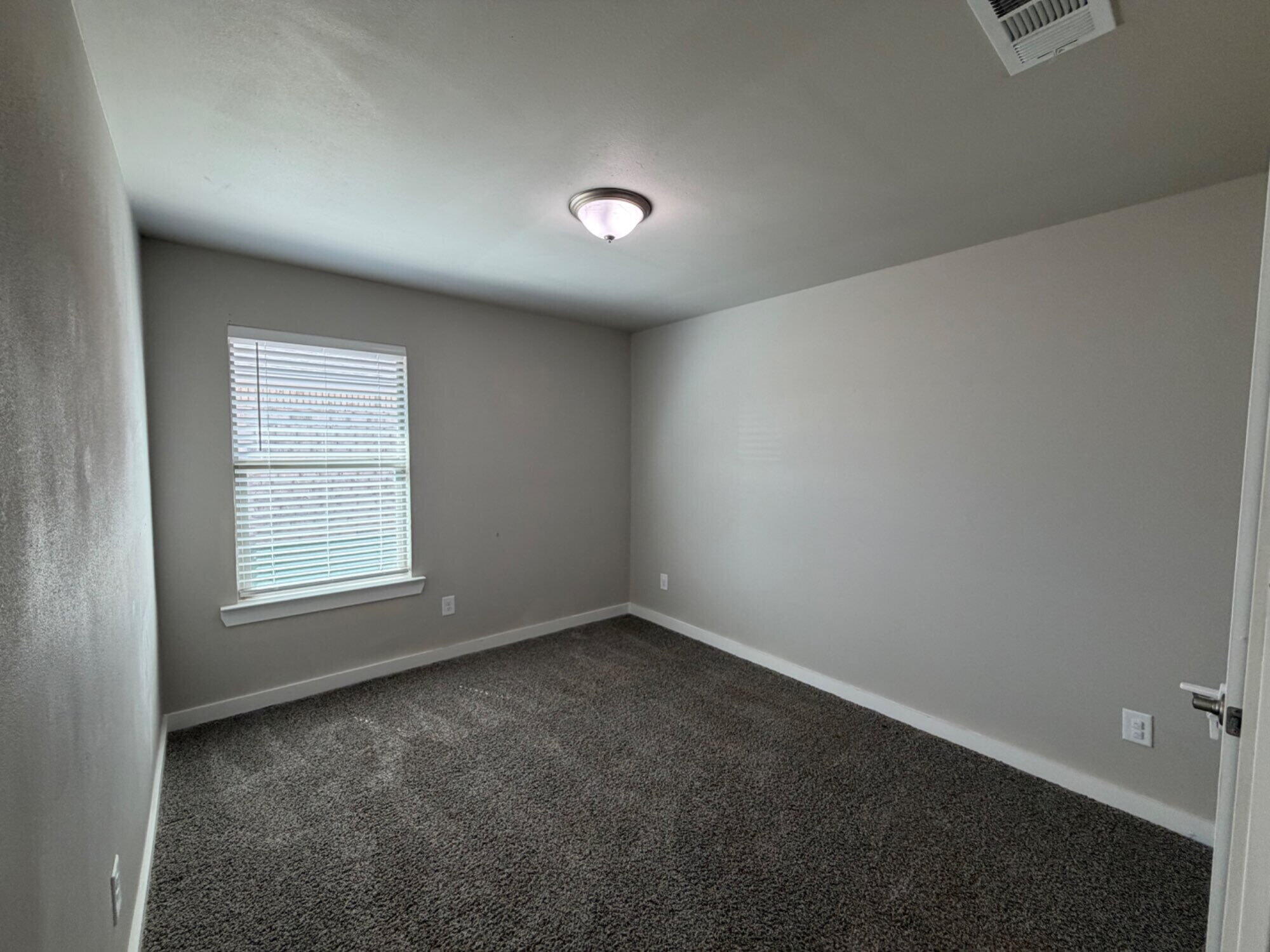 328 Ranger Street Wolfforth, TX 79382 - Photo 15 of 15 an empty room with a empty space and a window