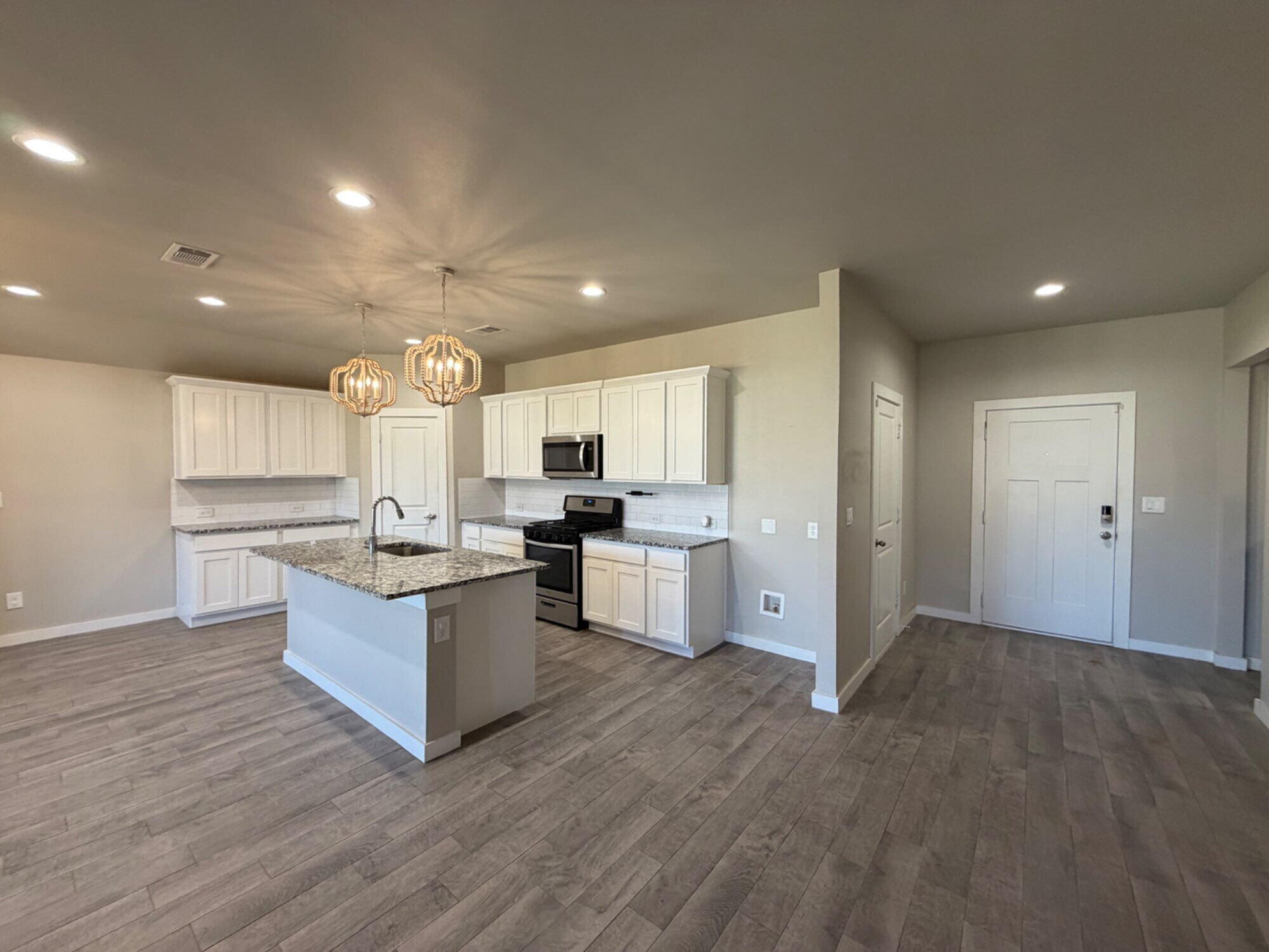 328 Ranger Street Wolfforth, TX 79382 - Photo 3 of 15 a large kitchen with lots of counter space and a sink