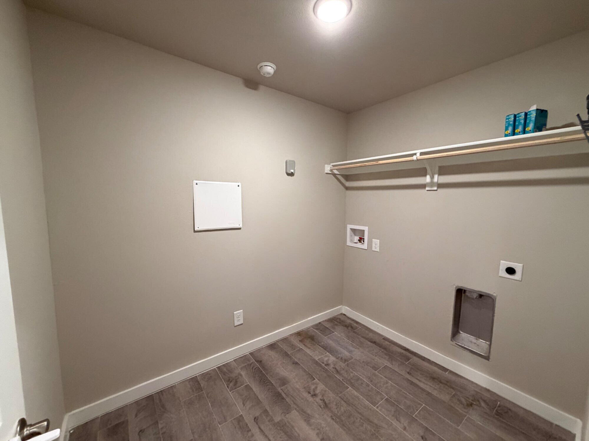 328 Ranger Street Wolfforth, TX 79382 - Photo 10 of 15 a view of a room with wooden floor and white walls