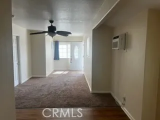 a view of hallway with a front door and wooden floor