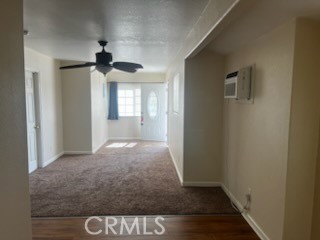 12204 14th Street, Unit A Yucaipa, CA 92399 - Photo 3 of 10 a view of hallway with a front door and wooden floor
