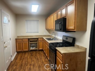 12204 14th Street, Unit A Yucaipa, CA 92399 - Photo 6 of 10 a kitchen with granite countertop a sink a counter space and cabinets