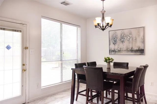 a view of a dining room with furniture and window