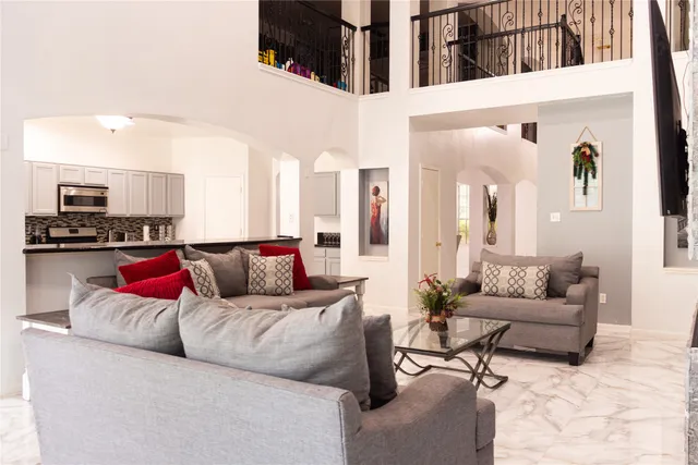 a living room with furniture and kitchen view