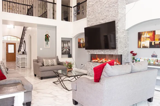 a living room with fireplace furniture and a flat screen tv