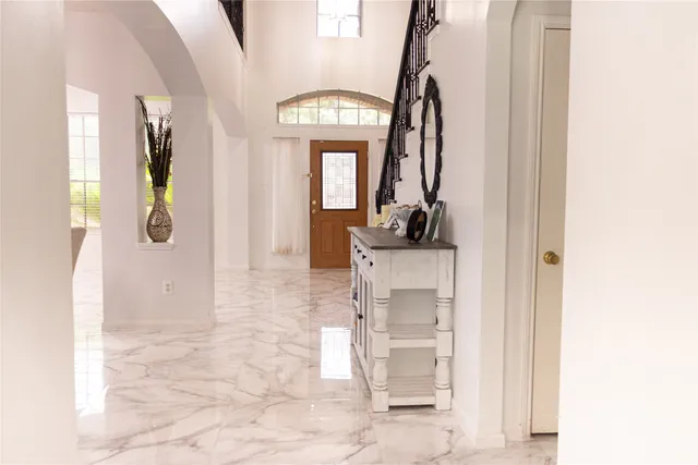 a view of entryway and hall with wooden floor