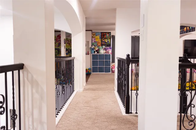 a view of a hallway with windows and entryway