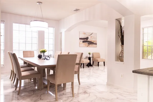 a dining room with furniture a window and a chandelier