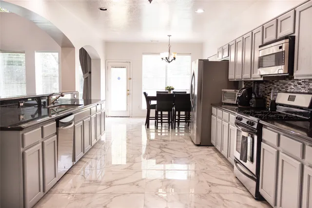a kitchen with stainless steel appliances a stove sink microwave and cabinets