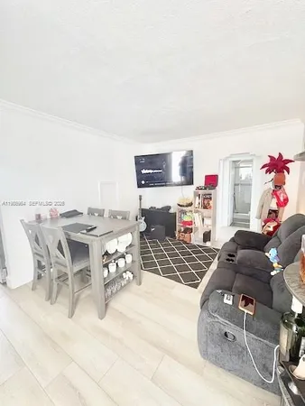 a dining room with furniture and a kitchen view