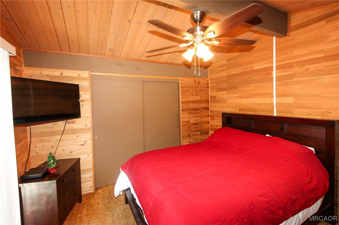 692 San Bernardino Avenue Sugarloaf, CA 92386 - Photo 12 of 20 a bedroom with a bed and a flat screen tv